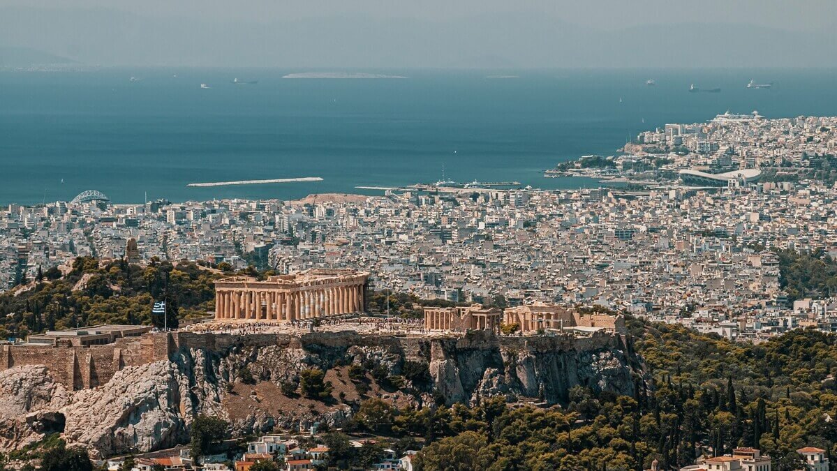 Panoramic view of the Acropolis of Athens with the Parthenon temple overlooking the city and the Aegean Sea.