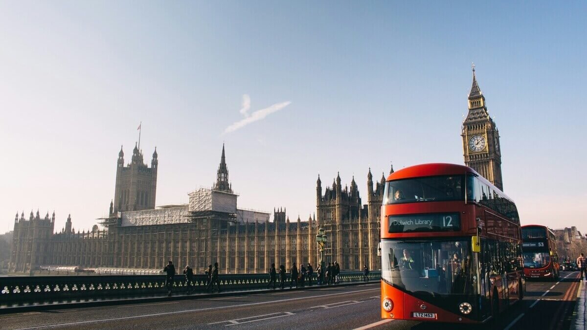 Iconic red double-decker bus and Big Ben representing travel to the United Kingdom.
