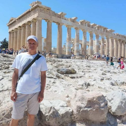Martin, travel blogger and author of Demvig Travel Blog, standing in front of the ancient Parthenon on the Acropolis in Athens, Greece.